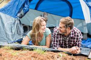 Young pretty hiker couple lying in a tent