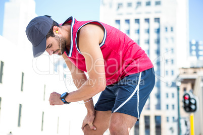 Exhausted athlete looking at his stopwatch