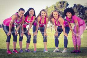 Five smiling runners supporting breast cancer marathon
