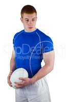 Serious rugby player holding rugby ball