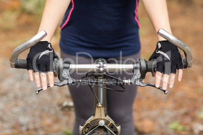 Close up view of hands on handlebar