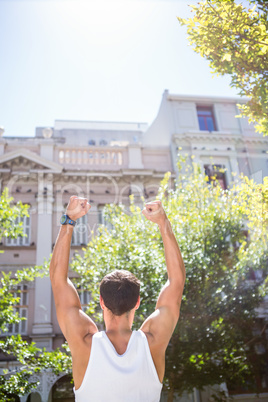 Rear view of an athletic man gesturing victory