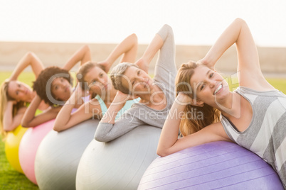 Smiling sporty women working out with exercise balls