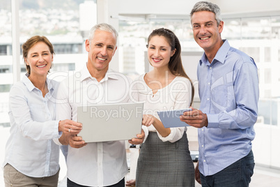 Smiling business people with laptop