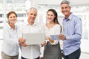 Smiling business people with laptop