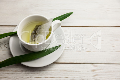 Cup of herbal tea on table