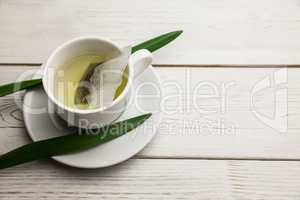 Cup of herbal tea on table