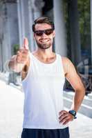 Smiling handsome athlete doing thumbs up