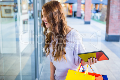 Pretty woman shopping at the mall using tablet