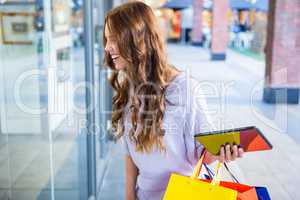 Pretty woman shopping at the mall using tablet