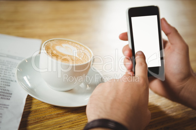 High angle close-up of coffee and smartphone