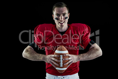 American football player holding a ball