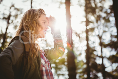 Pretty blonde hiker looking for path