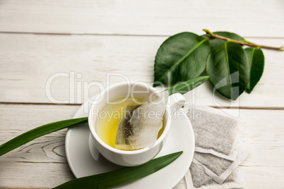 Cup of herbal tea on table