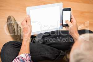 Casual man sitting and using smartphone