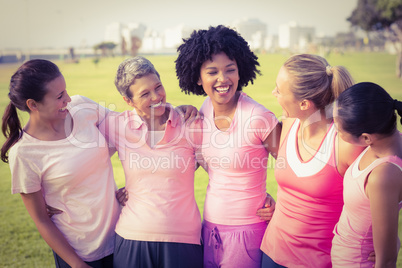 Laughing women wearing pink for breast cancer