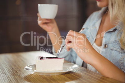 Woman enjoying cake and coffee