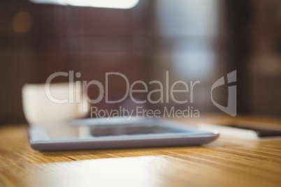 Close-up of digital tablet and coffee on table Close-up of digital tablet and coffee on table