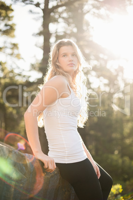 Young jogger leaning on rock