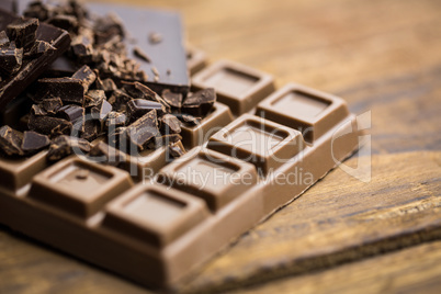 Dark and milk chocolate on a wooden table