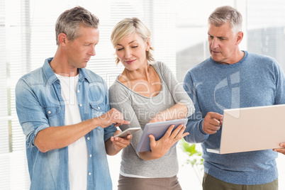 Attentive business colleagues using electronic devices