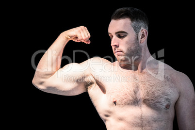 Strong bodybuilder flexing his bicep