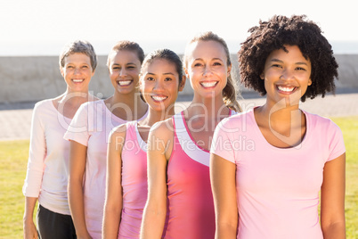 Smiling women wearing pink for breast cancer