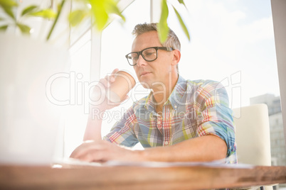 Casual designer drinking out of take-away cup