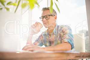 Casual designer drinking out of take-away cup