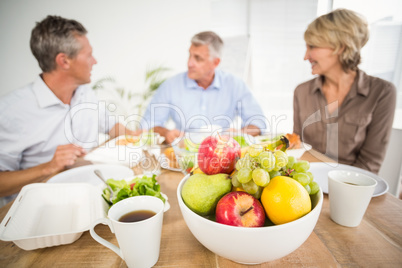 Smiling business colleagues having lunch together