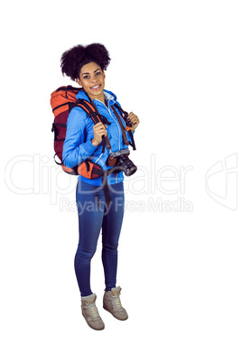 Portrait of a young woman with camera and backpack