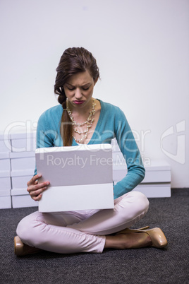 Sad brunette looking in shoe box