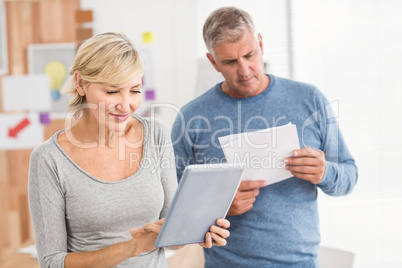 Attentive business colleagues reading and using tablet