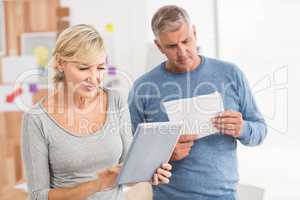 Attentive business colleagues reading and using tablet