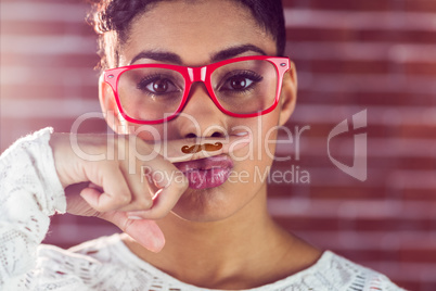 Portrait of a happy hipster wearing a fake mustache