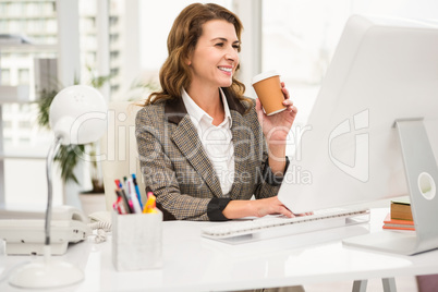 Casual businesswoman working and having coffee