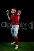 American football player throwing football