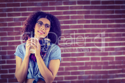 Attractive hipster holding take-away cup