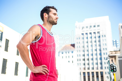 Serious handsome athlete with hands on hips