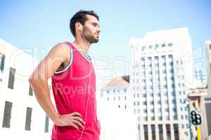 Serious handsome athlete with hands on hips