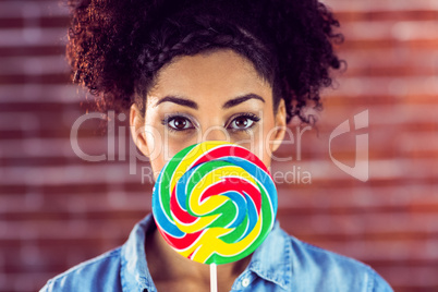 Portrait of a beautiful woman holding a giant lollipop