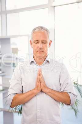 Peaceful casual businessman meditating