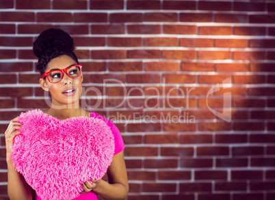 Portrait black hair model holding a pink heart shaped pillow