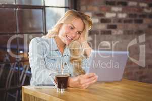 Smiling blonde holding tablet computer