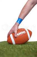 American football player placing the ball