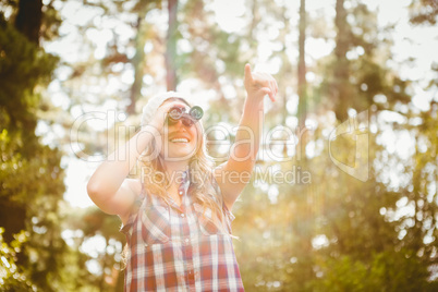 Pretty young blonde looking through binoculars