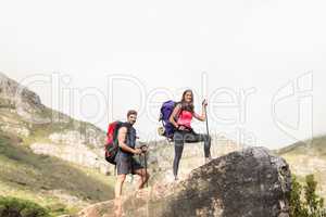 Young happy joggers standing on rock