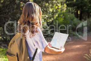 Brunette hiker reading map