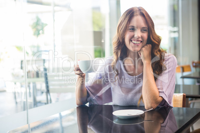 Pretty brunette enjoying a coffee