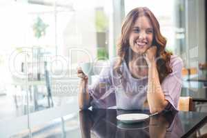 Pretty brunette enjoying a coffee